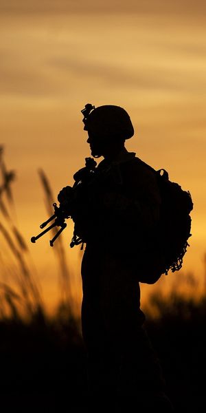 4k Silhouetted Soldier with Assault Rifle at Sunrise