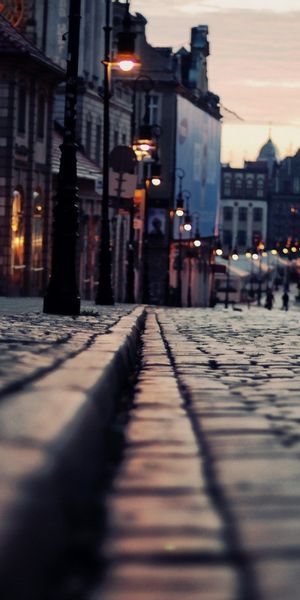 Charming Cobblestone Road at Night with Lights