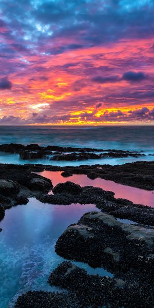 Breathtaking Sunset Over Ocean Rocks - Perfect Mobile Wallpaper