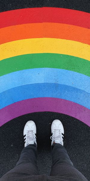 Vibrant Rainbow Background with Sneakers on Asphalt for Unique Decor