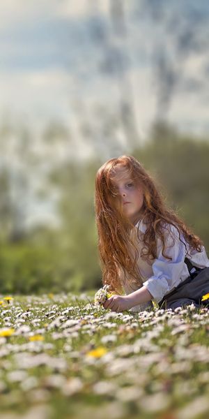 Enchanting Summer Scene with a Little Girl Among Flowers