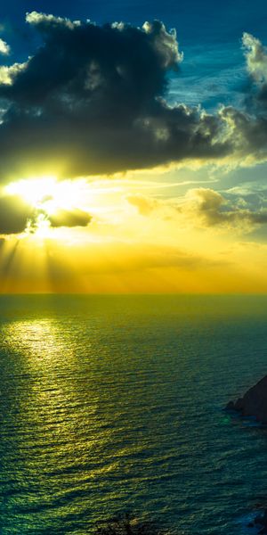 Breathtaking Sunset Over the Ocean with Sunbeams