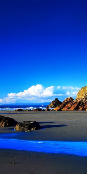 Beautiful Beach Landscape with Blue Sky and Rocky Mountains