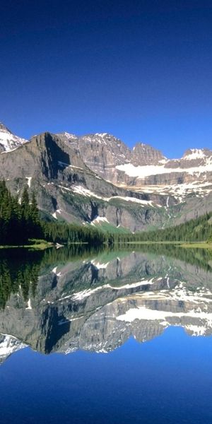 Breathtaking mountain landscape wallpaper featuring snow-capped peaks and serene reflections