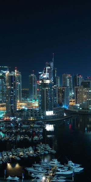 Dubai Night Skyline with Boats and Skyscrapers