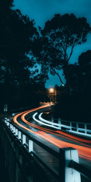 Winding Road with Glowing Lights in Long Exposure at Night