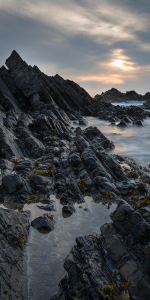 Breathtaking Sunset Over Rocky Coastline