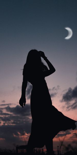 Silhouette of a Girl at Dusk with a Beautiful Moon