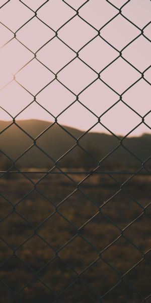 High-Quality Nature Sunset Through a Chain Link Fence