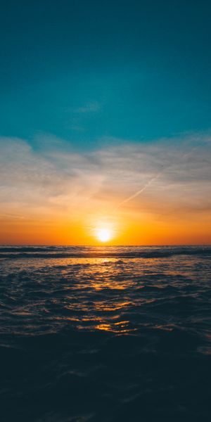 Breathtaking sunset wallpaper featuring waves and horizon for your phone