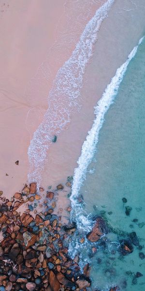 Aerial View of Ocean Waves and Sandy Beach