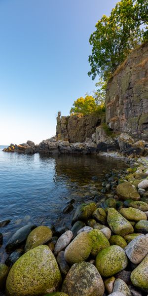 Tranquil Coastal Scene with Pebbles and Clear Waters