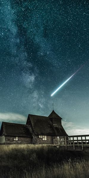 Enchanting phone wallpaper featuring a bridge, meteorite, and starry night sky