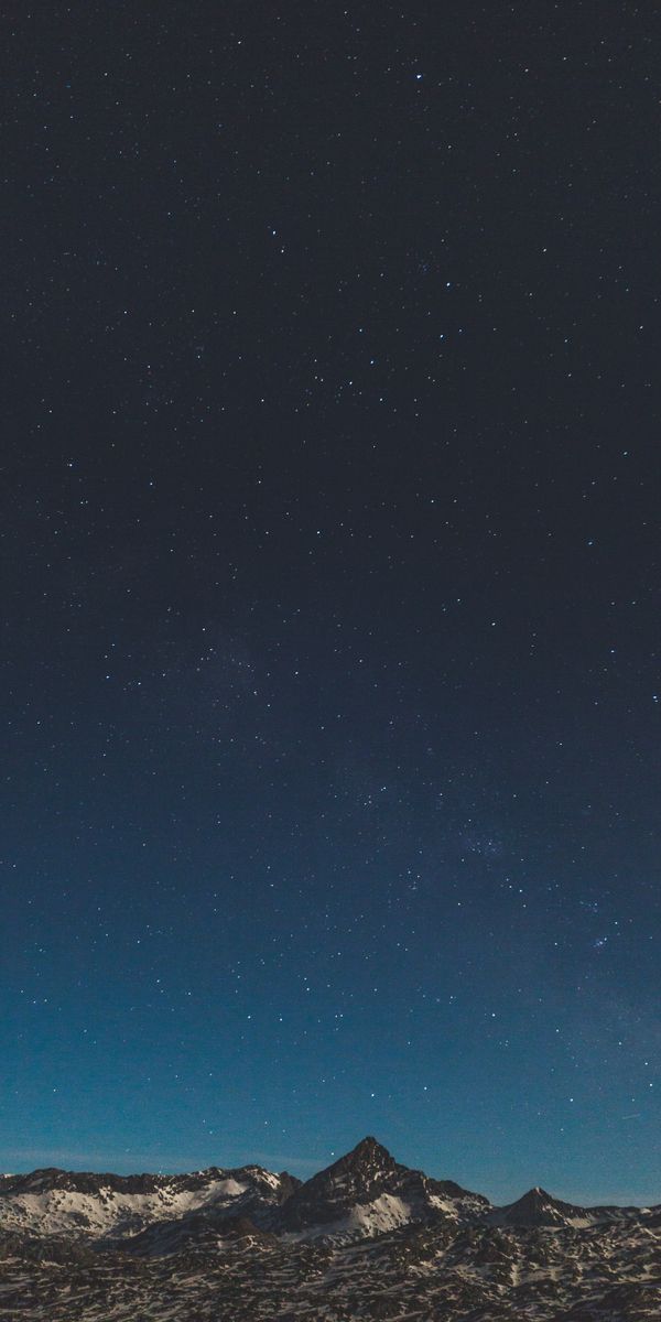 Breathtaking Night Sky Over Snowbound Mountains