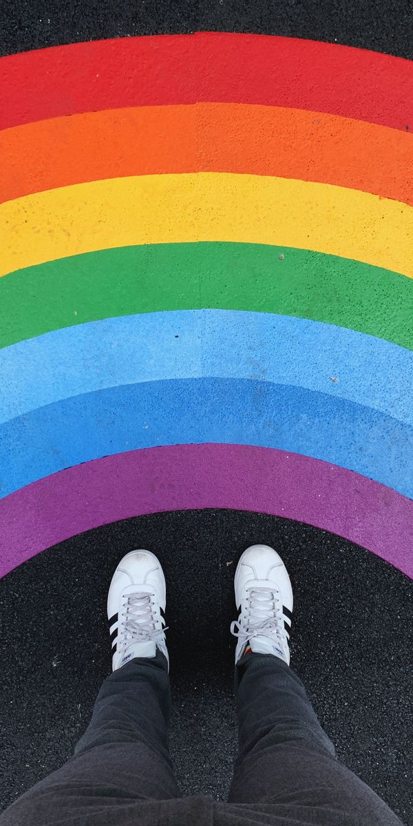 Vibrant Rainbow Background with Sneakers on Asphalt for Unique Decor