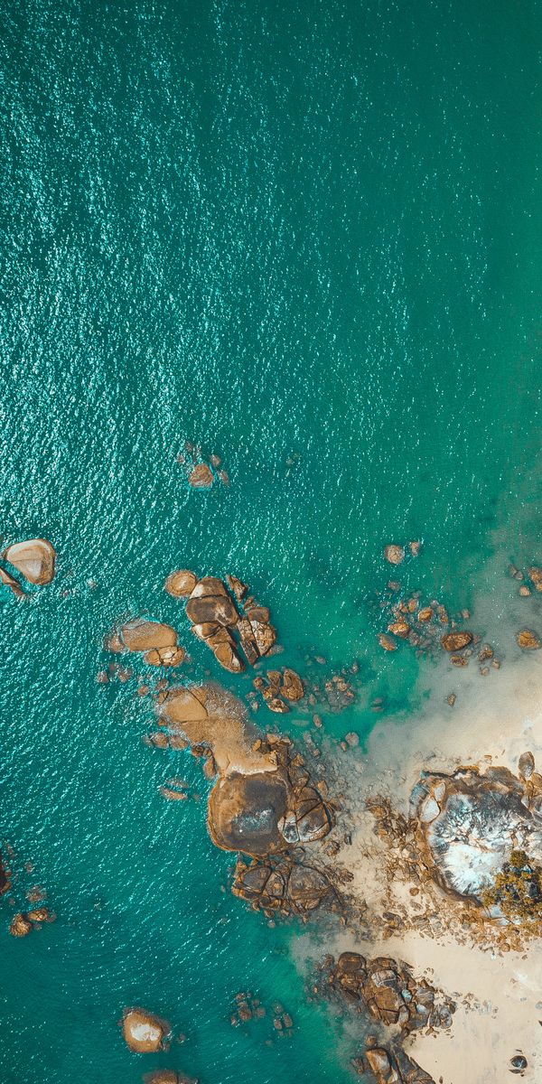 Breathtaking Aerial Beach View with Vibrant Sea and Rocks