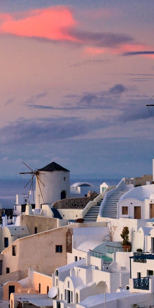 Breathtaking 4K wallpaper featuring a coastal city with windmills and sunset