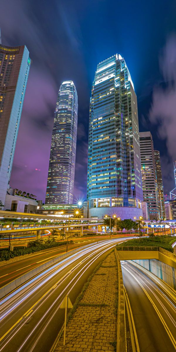 Free wallpaper of a bustling night city with skyscrapers and neon lights