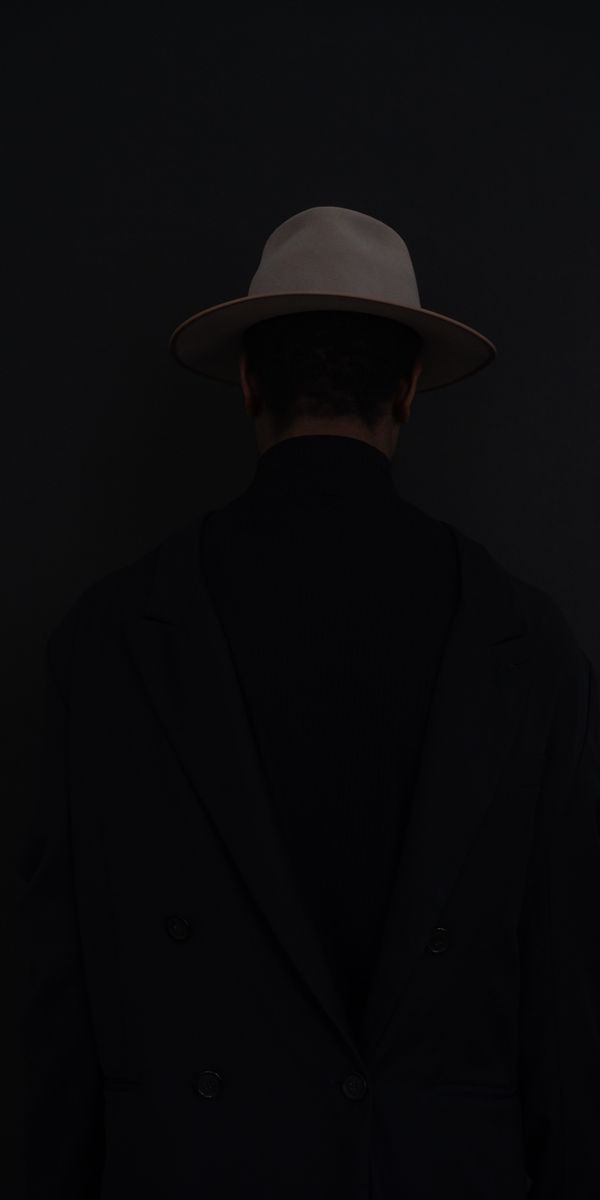 Mysterious Dark Wallpaper with a Stylish Figure in a Hat