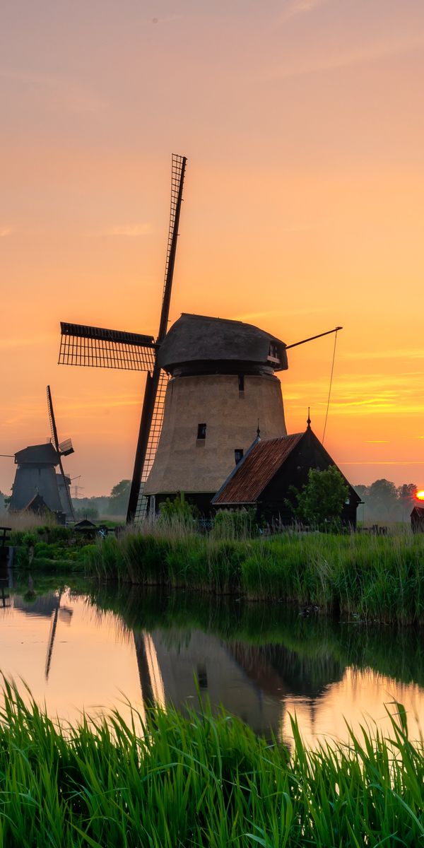 Aesthetic Sunset Over Windmills and Serene Rivers
