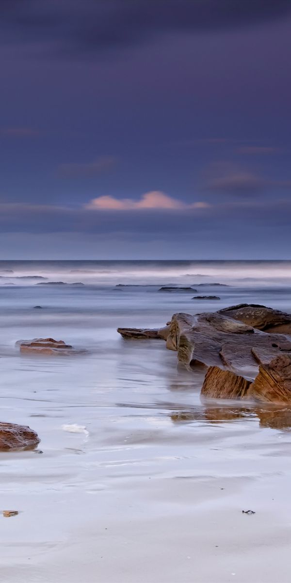 Serene Beach Scene with Stones Perfect for Mobile Wallpaper