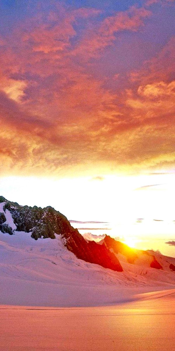 Breathtaking Sunset Over Snow-Capped Mountains