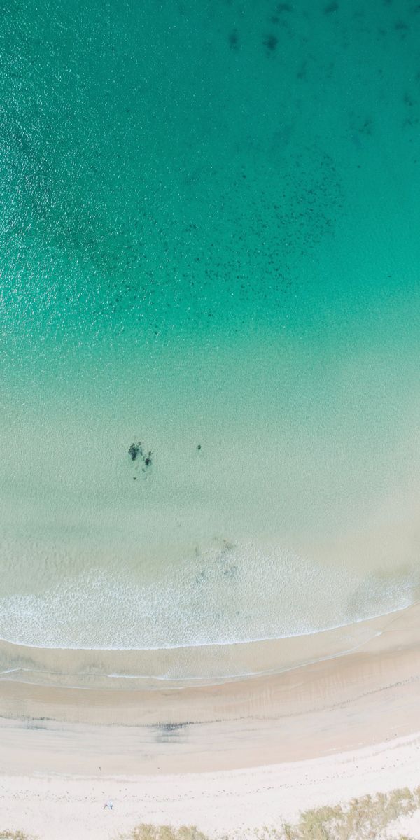 Aerial View of a Serene Beach and Clear Sea
