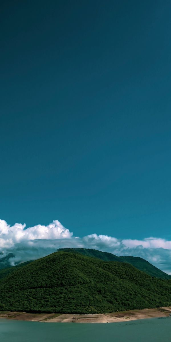 Breathtaking Island Landscape with Lush Hills and Clouds