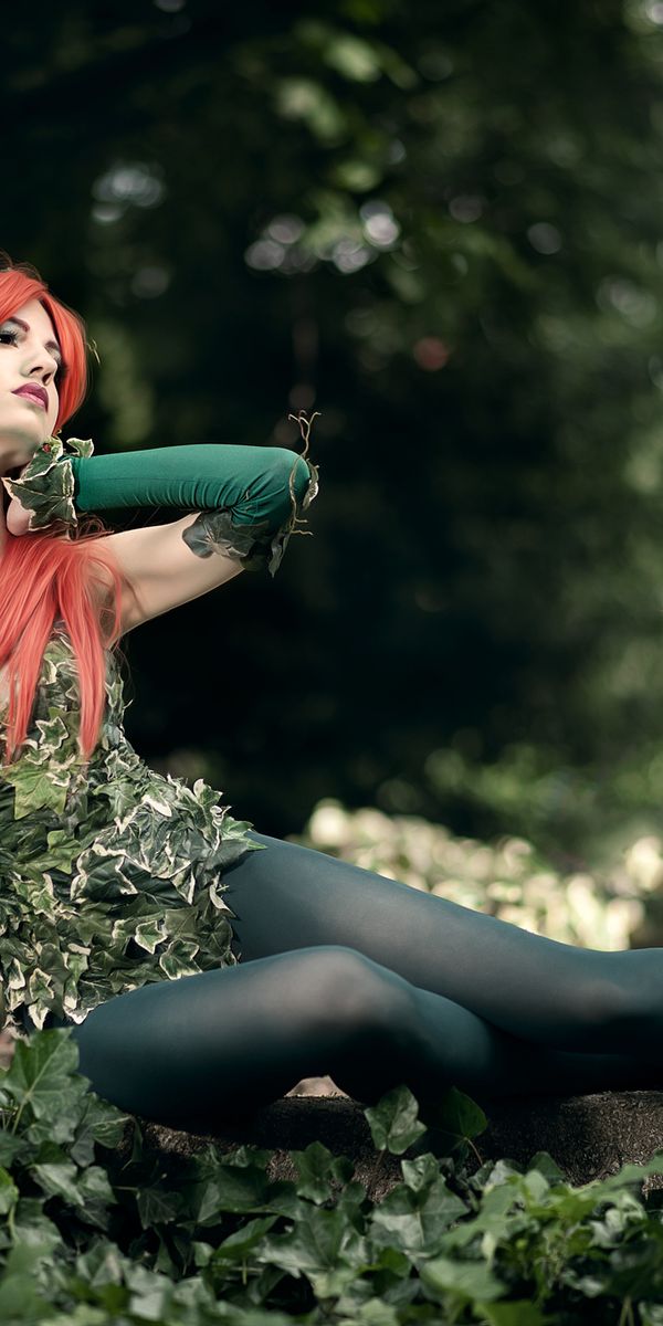 Enchanting Poison Ivy Cosplay Mobile Wallpaper with Nature and Red Hair