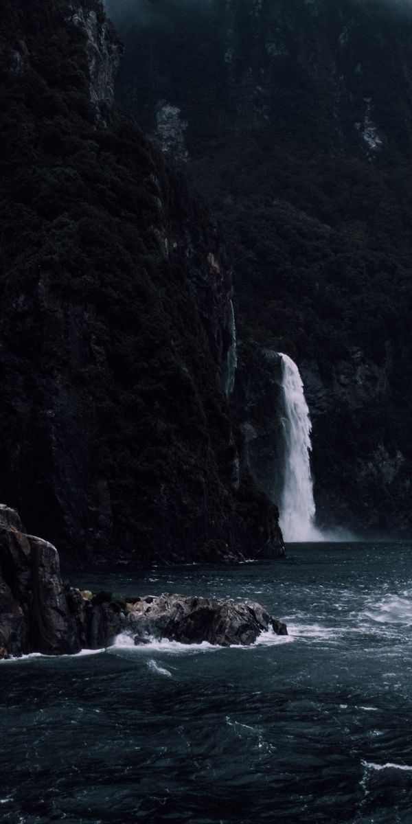 Majestic Waterfall Cascading from Cliff into the Sea