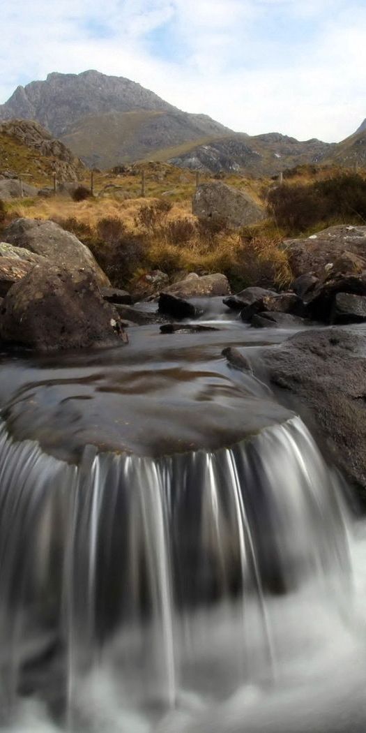Serene Mountain River Flowing Through Stones