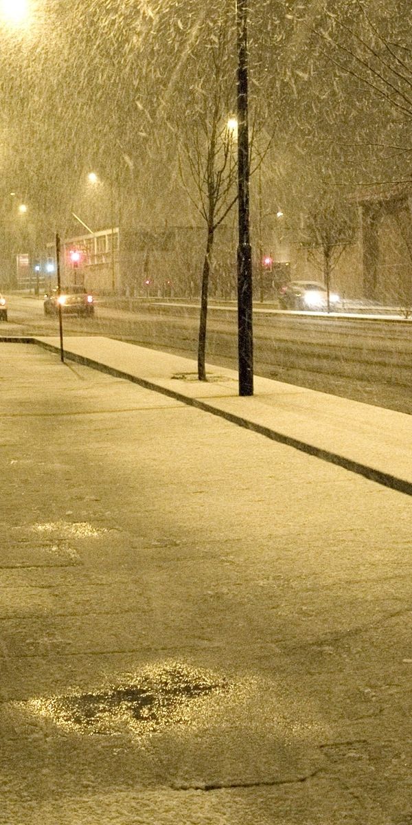 Snowy Telephone Booth on a Winter Night Street