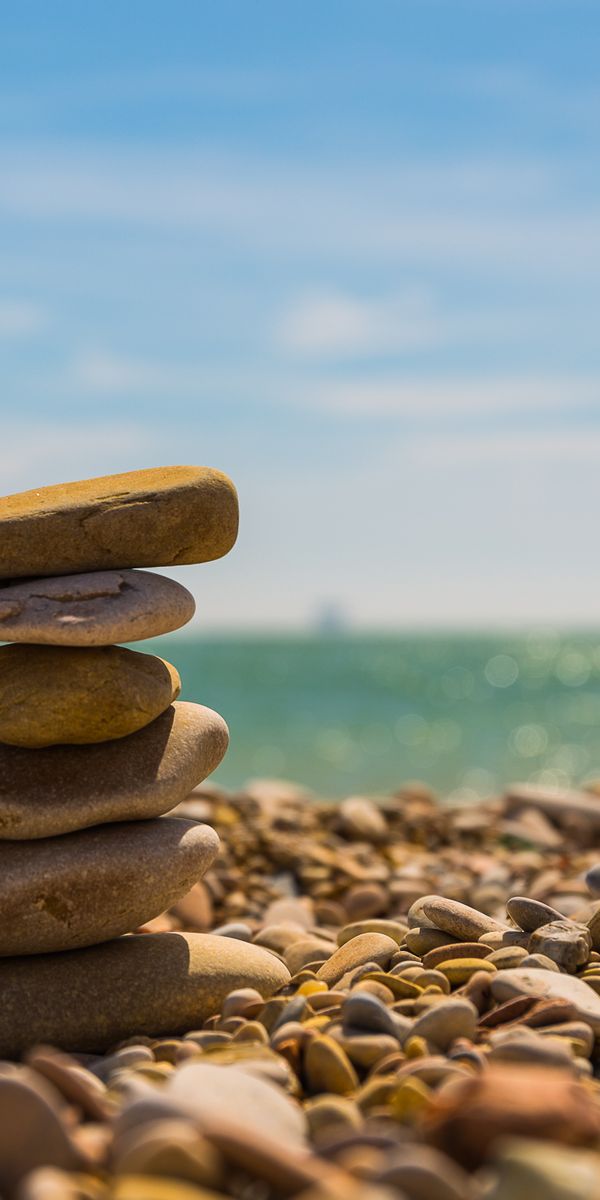 Beautifully Stacked Stones on a Tranquil Beach