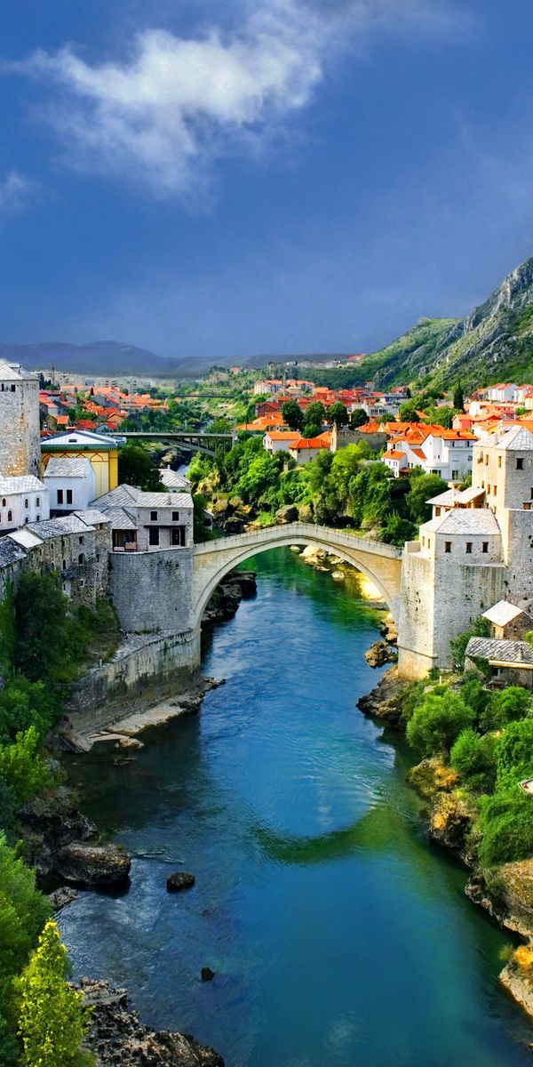 Breathtaking View of a Town in the Alps with a Scenic Bridge