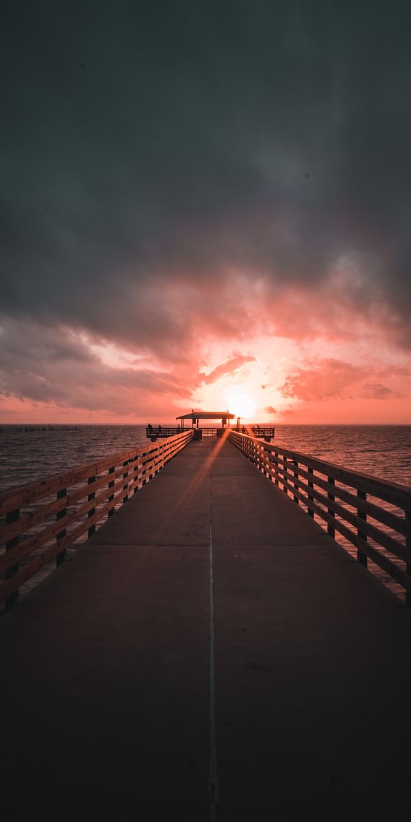 Breathtaking Sunset at the Pier with Overcast Sky