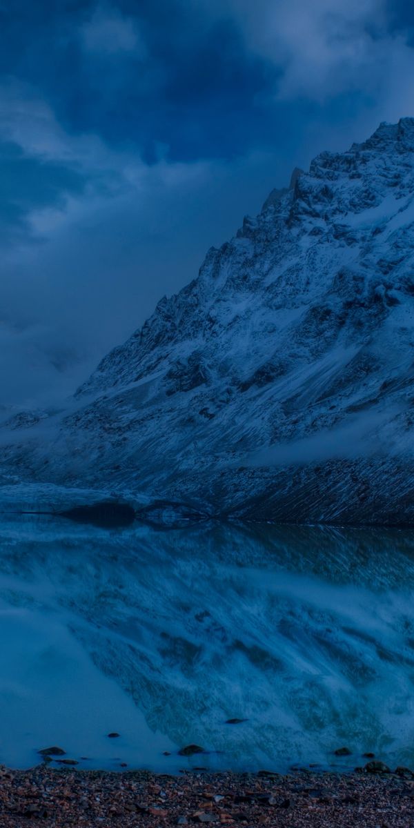 Majestic Winter Scene with Moonlit Reflection in a Mountain Lake