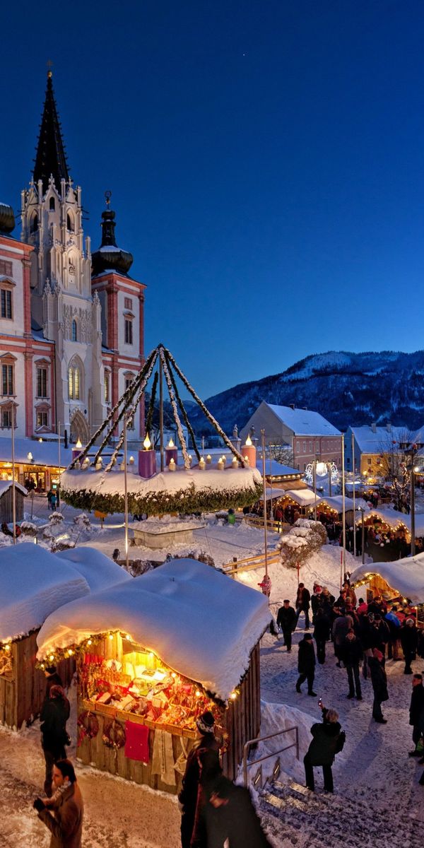 Enchanting Night View of a Christmas Market in a Snowy City