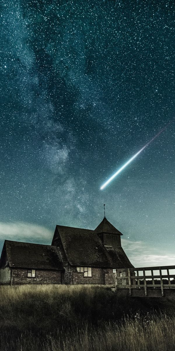 Enchanting phone wallpaper featuring a bridge, meteorite, and starry night sky