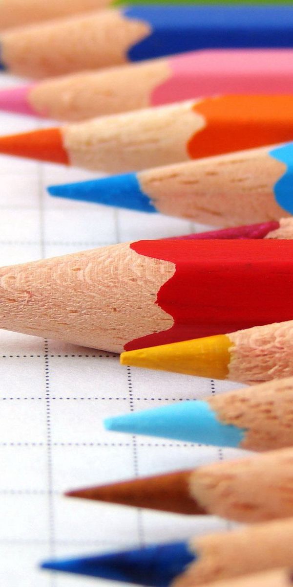 Vibrant Multicolored Pencils on a Notebook
