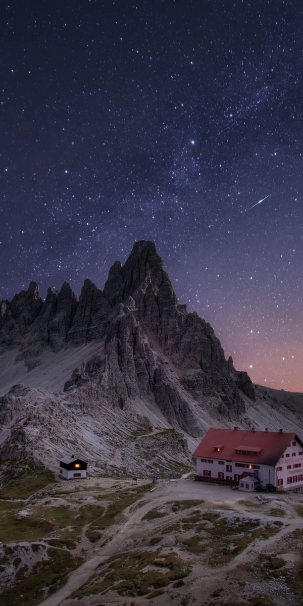 Starry Sky Over Mountains with Charming Houses