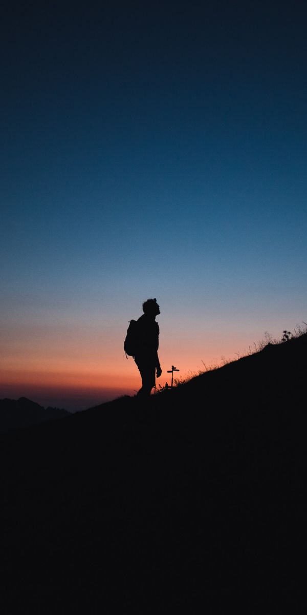 Lonely Journey: Silhouette on a Mountain at Night