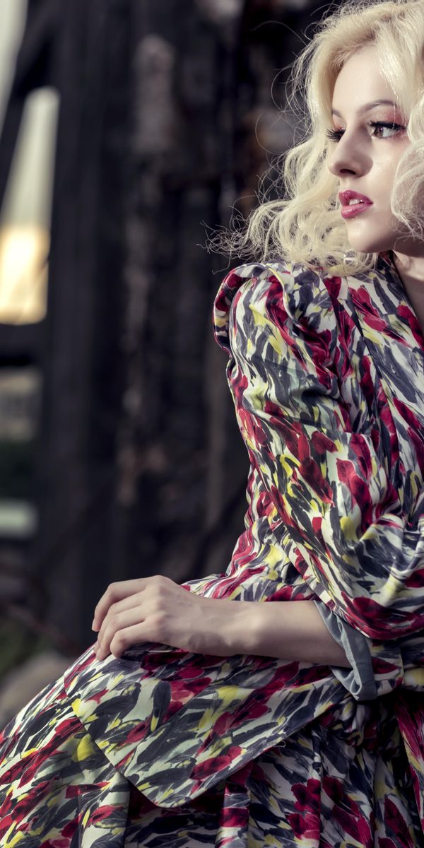 Charming blonde model in a colorful robe against an urban backdrop, 4K wallpaper