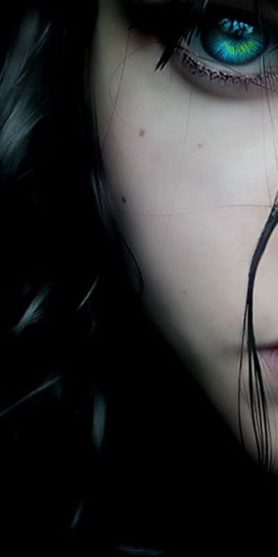 Mesmerizing HD wallpaper of a woman with dark hair and vivid blue eyes