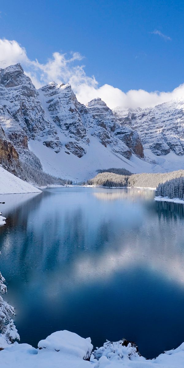 Breathtaking Winter View of Snow-Capped Mountains and Calm Lake