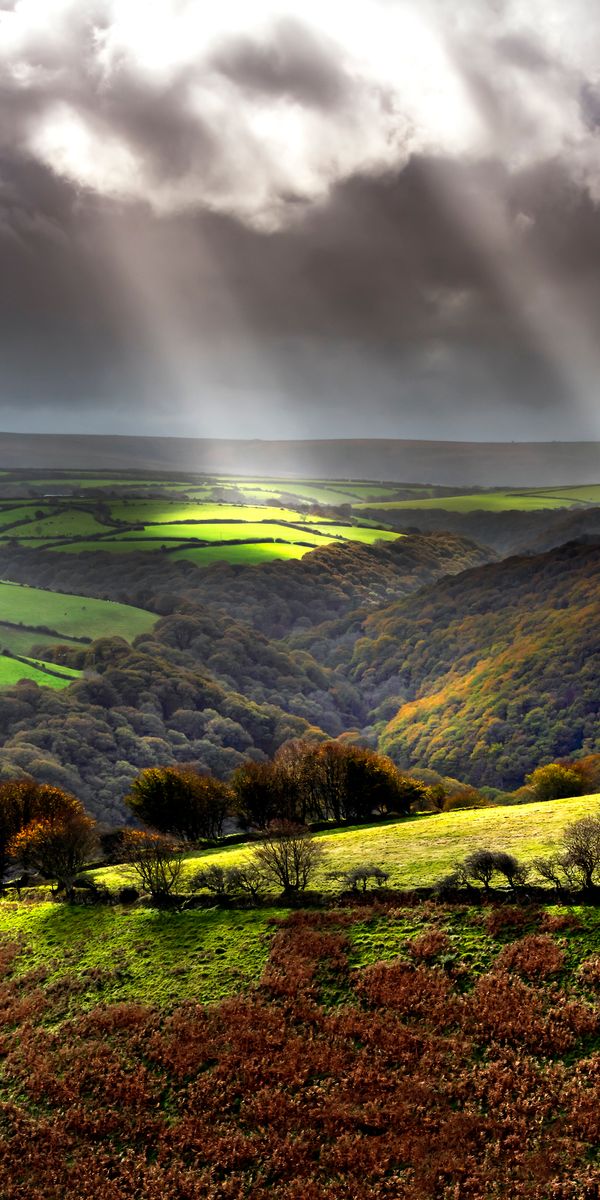 Breathtaking Landscape with Rolling Hills and Dramatic Sky