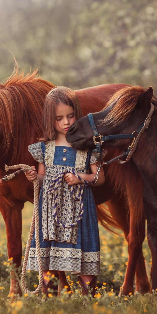 Enchanting HD iPhone Wallpaper of a Little Girl with a Pony in Nature