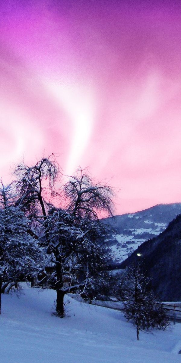 Breathtaking Aurora Borealis Above Snowy Mountains