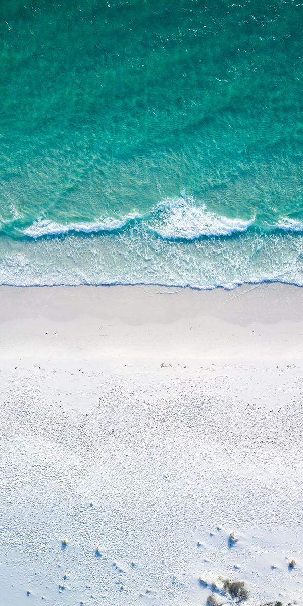 Aerial View of a Pristine Beach and Ocean Waves