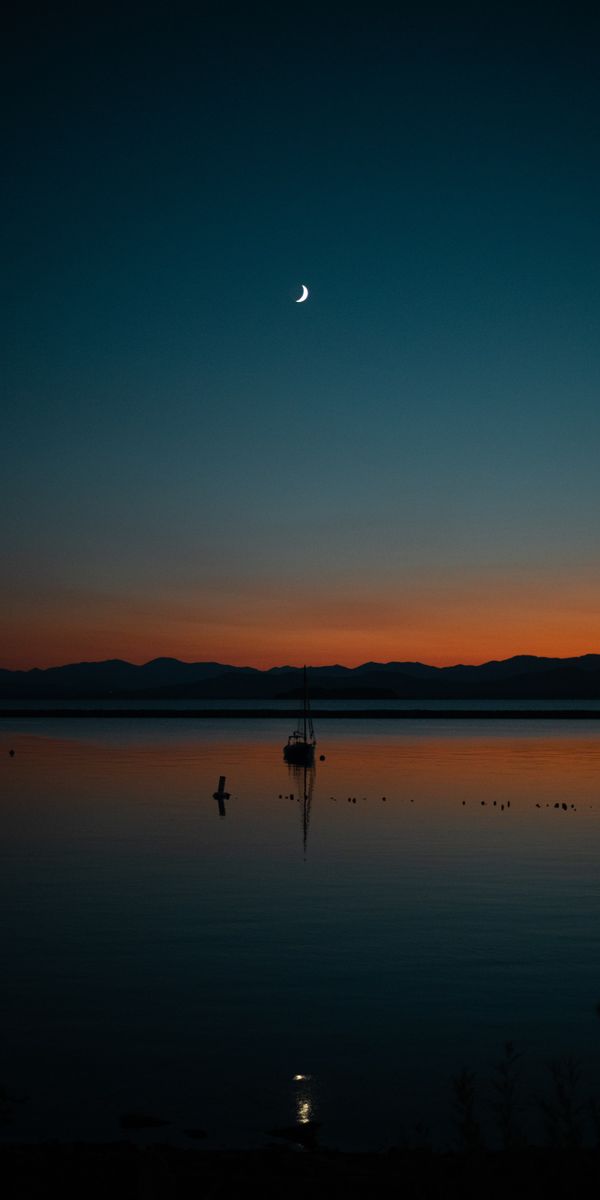 Beautiful Sunset with Sailboat - Ideal for Your Mobile Wallpaper