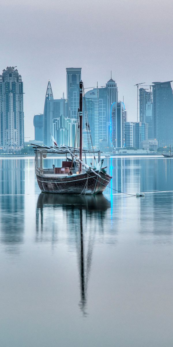 Doha Skyline with Traditional Boats - A Serene Mobile Wallpaper